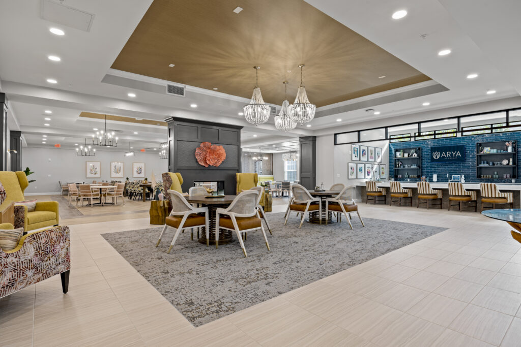 Elegant community lounge area featuring cozy seating, stylish chandeliers, and open spaces ideal for social gatherings.