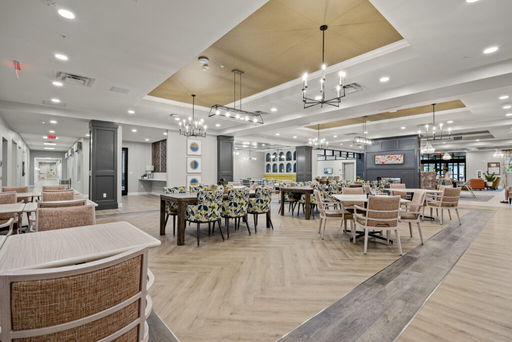 Modern, open-plan dining room with mixed seating, subtle decor, and ample lighting perfect for comfortable dining.