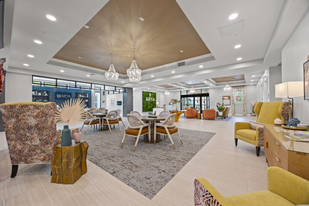 Modern activity space featuring sleek furniture, decorative walls, wooden ceiling details, and a warm inviting atmosphere.