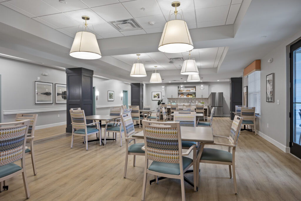 Alternative angle of the spacious dining room showing abundant seating and lighting fixtures.