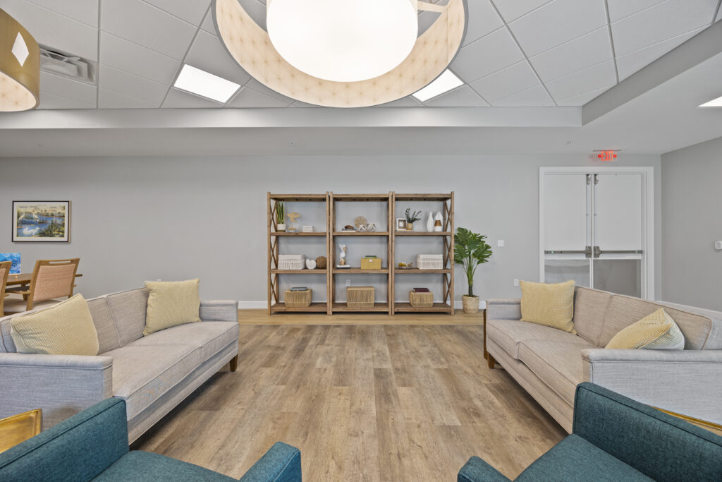 Activity room set up for leisure with tables, board games, and comfortable seating arrangements.