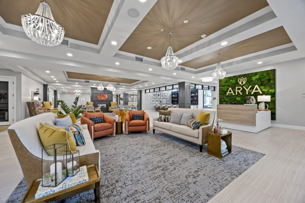 Elegant community lounge area featuring cozy seating and stylish chandeliers